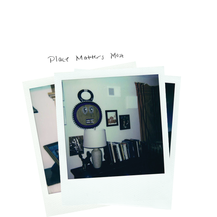 A few stacked Polaroid photographs, the top image of the interior of a house with a handwritten note which says "Place Matters Most"