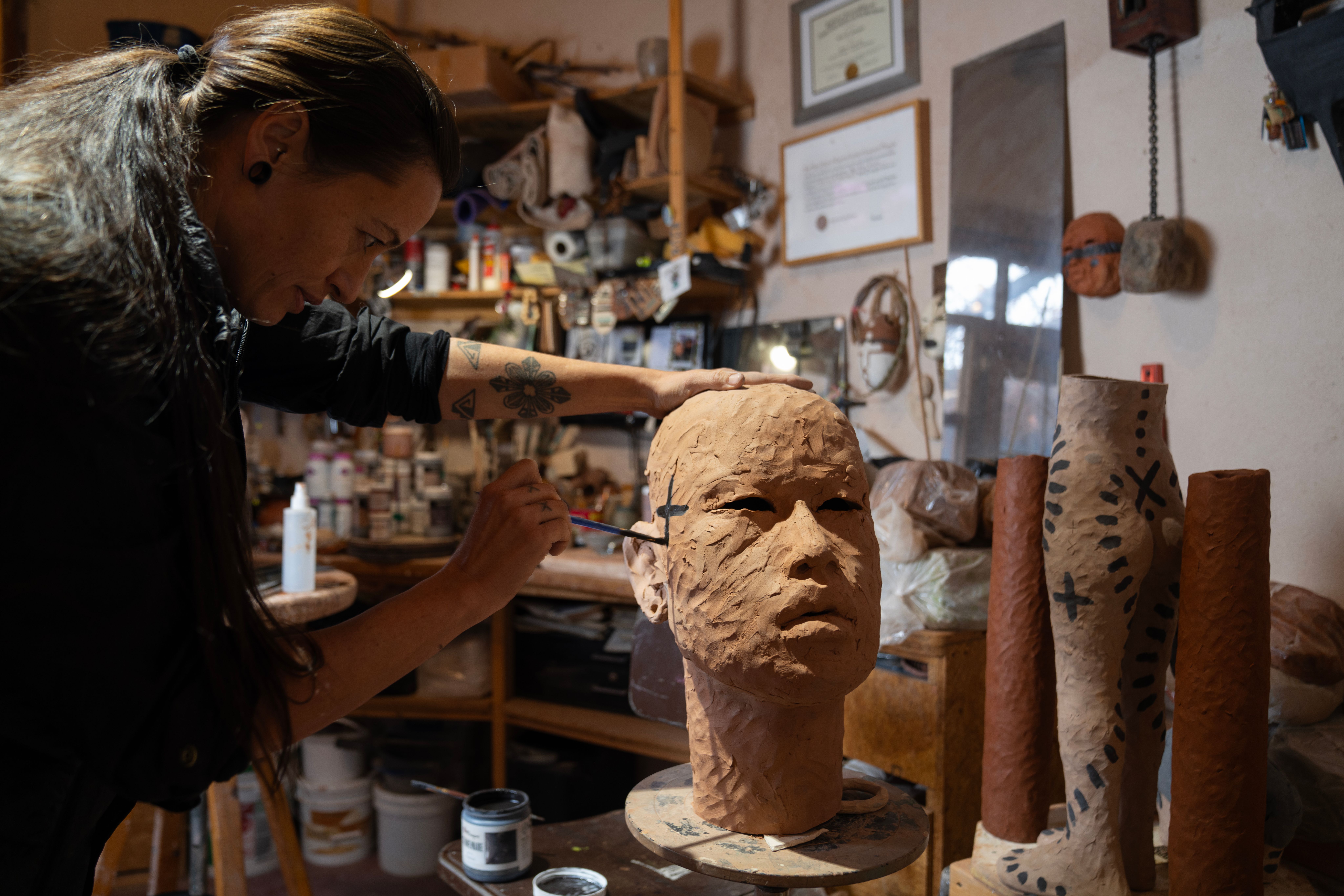 Rose working on a large clay bust 