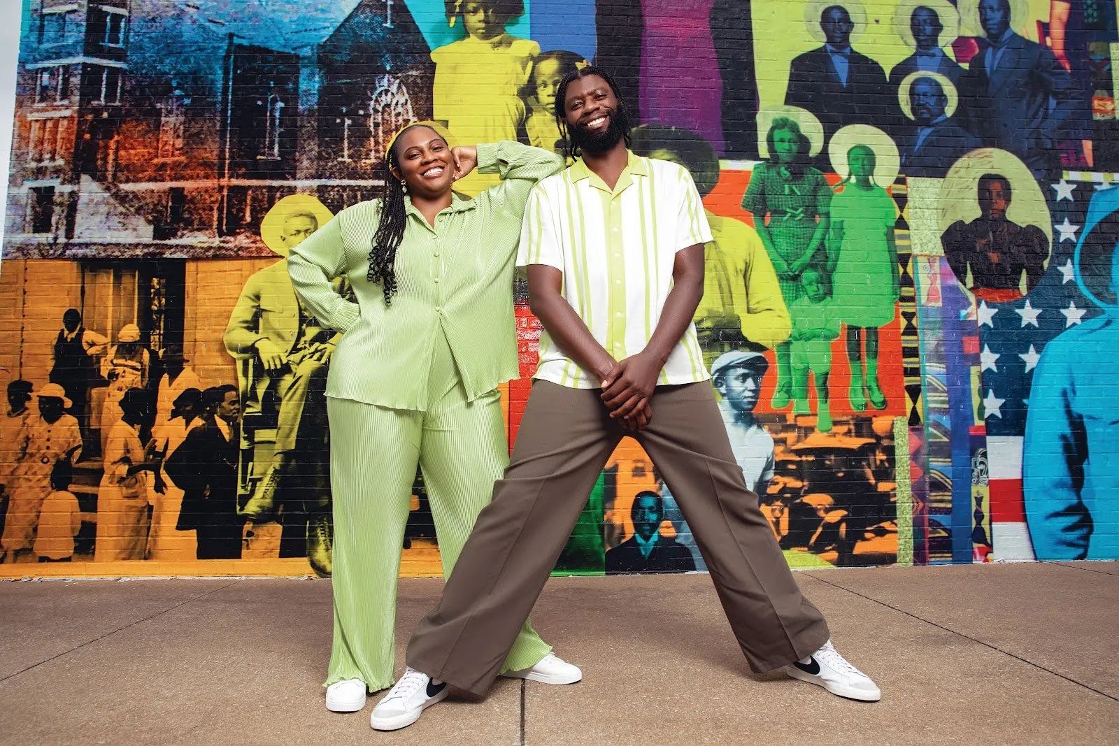 Tameshia Rudd-Ridge and Jourdan Brunson standing in front of colorful mural featuring archival photographs