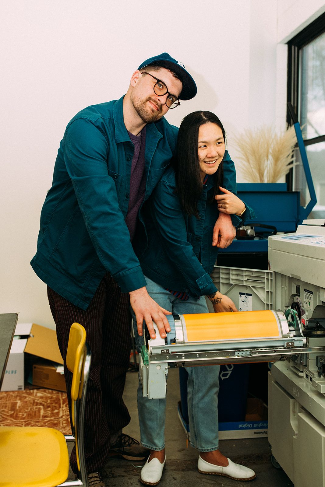 Ben & Diana loading a drum into a risograph machine