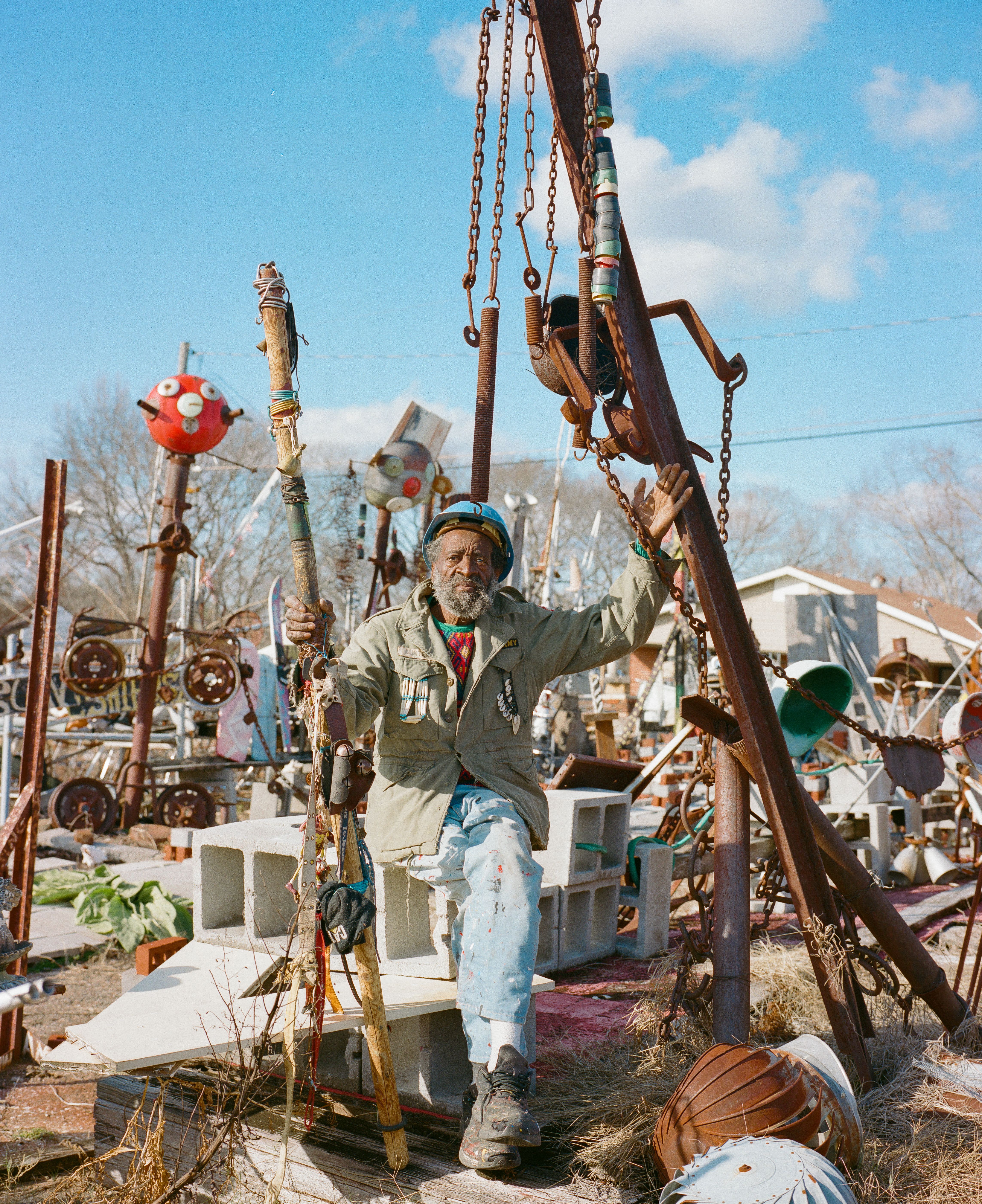 Joe Minter in his outdoor studio with monumental, handmade sculptures