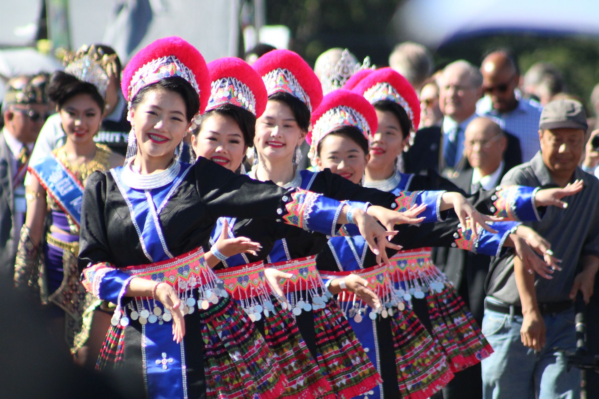A group og smiling young women performing in traditional Hmong clothing