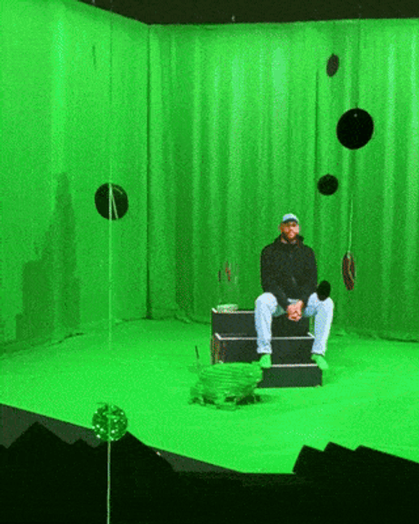 portrait of Will Rawls standing outside in front of a wall with stone bricks and next to a stained glass window