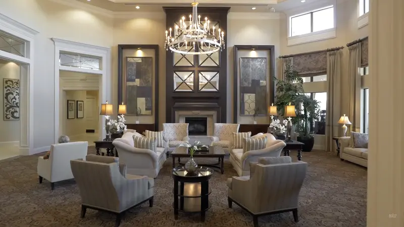 Luxurious seating area in Valencia Cove lobby with a grand chandelier and fireplace.