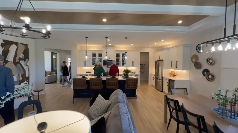 Interior view of a spacious, well-lit kitchen and living area with modern furnishings.