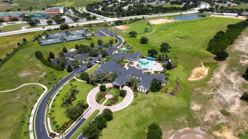 Aerial view of the Summit Greens clubhouse with grand entrance and surrounding amenities.