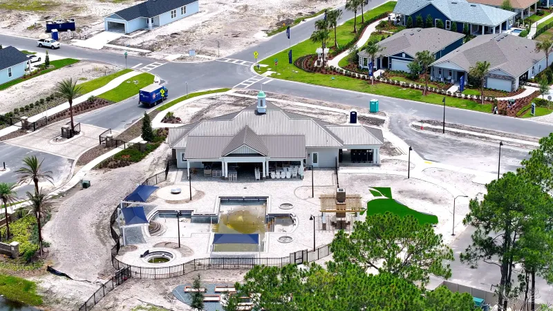 A closer look at the clubhouse under construction, highlighting residences and community facilities.