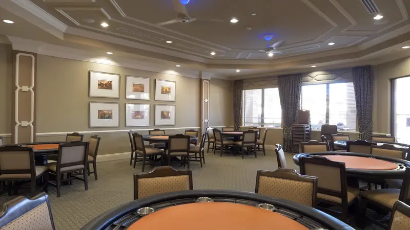 Card room at Valencia Cove with multiple tables and a sophisticated design.