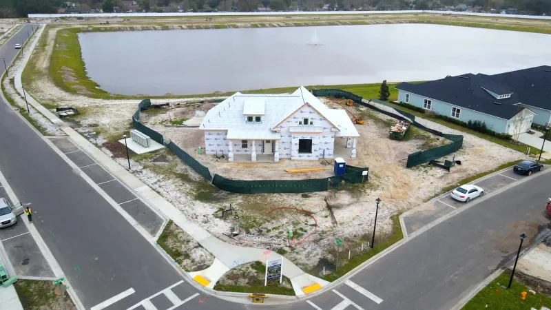 Bird's-eye view of the Lake House Amenity Center, showcasing the serene lake in the backdrop.