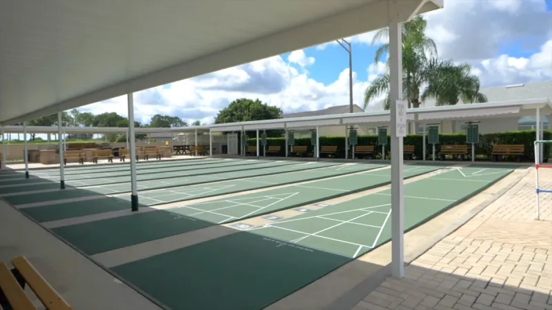 Multiple shuffle board courts and covered areas for shade.