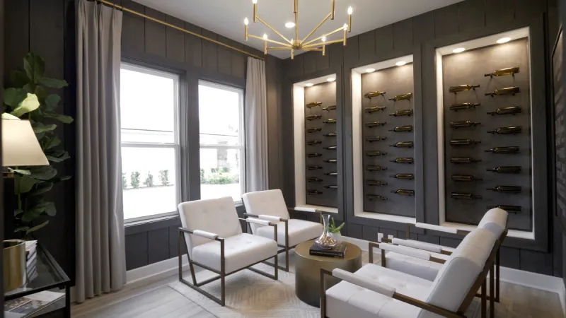 Beautiful wine room with plush white chairs in the Reverie at TrailMark model home.