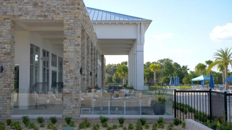 Exterior seating areas behind the Twin Lakes community clubhouse.