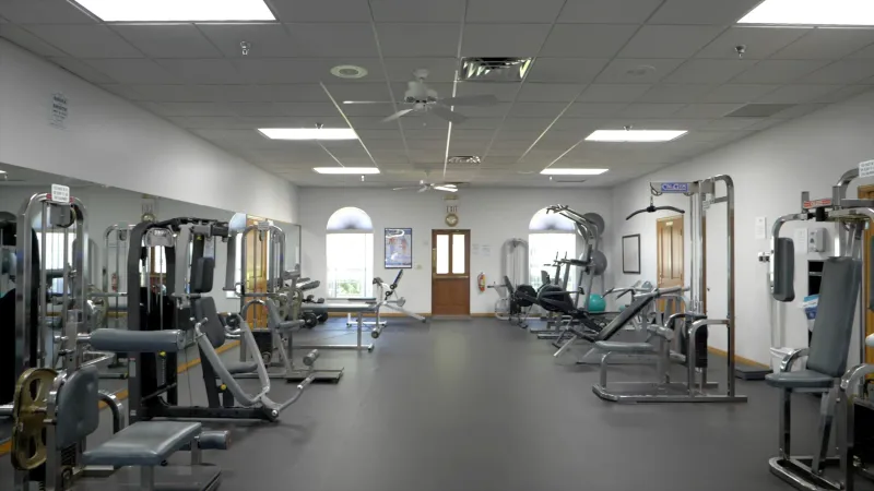 Spruce Creek South's well-equipped fitness center with various exercise machines and a clean spacious layout.