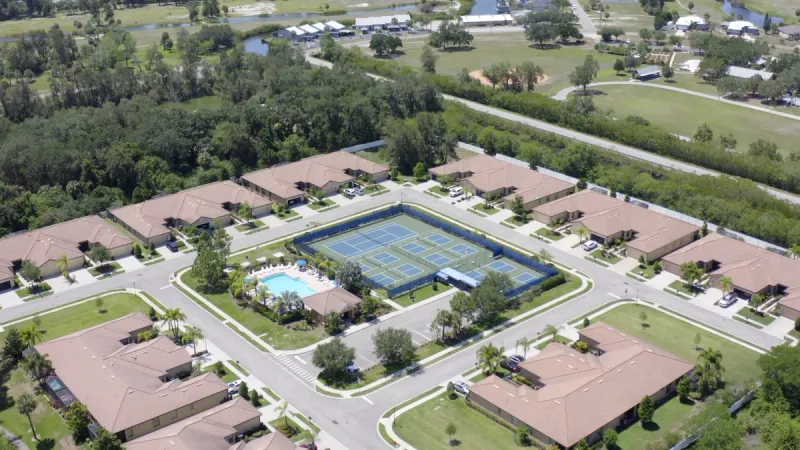 A Southshore Falls amenity center with a pool and sports courts nestled in the center of villa-style homes.