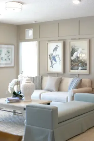Gatherings of Lake Nona model living room with couches and wall art in model home.