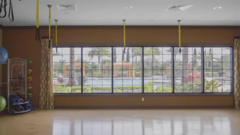 Aerobics room with TRX suspension bands and exercise balls.