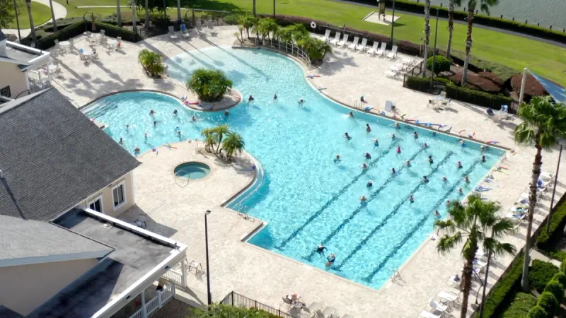 A bird's-eye view of a bustling outdoor swimming pool in Lakes of Mount Dora.