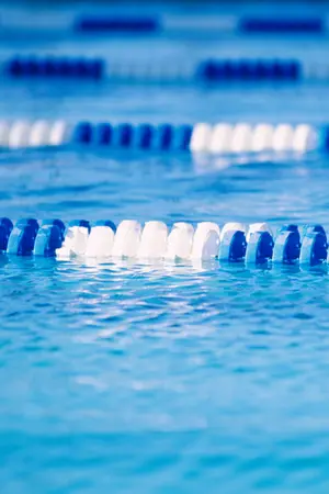 A clear blue swimming pool with a series of lane dividers.