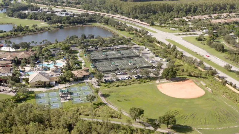 An aerial view captures the bustling tennis courts at Pelican Preserve.