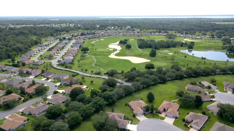 Beautiful homes in the foreground set against the lush expanse of a golf course in the background.