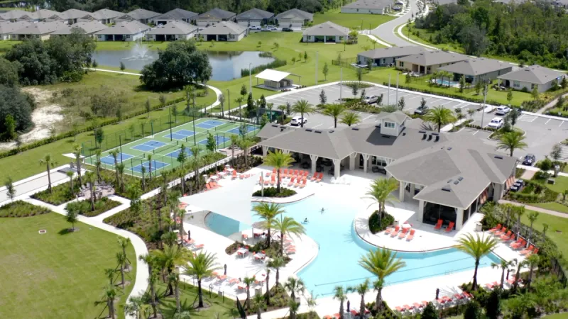 Aerial view of the Palms at Serenoa pool, lounge areas, and sports courts.