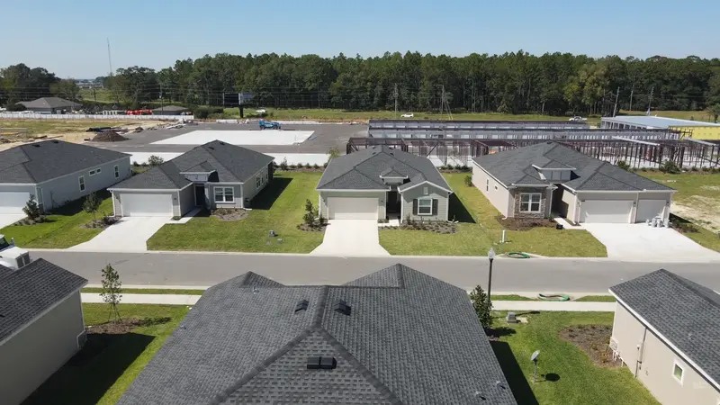 Row of completed homes in Liberty Village, Ocala, FL, showcasing the uniform and attractive architecture of this 55+ community.