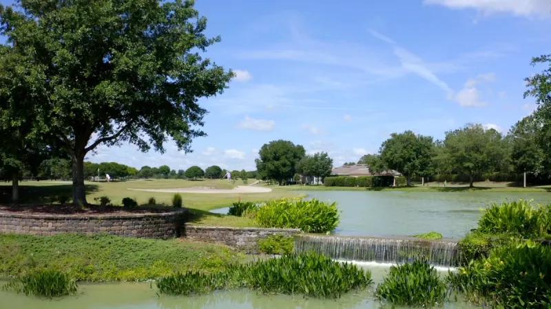 Golf course surrounding by pond