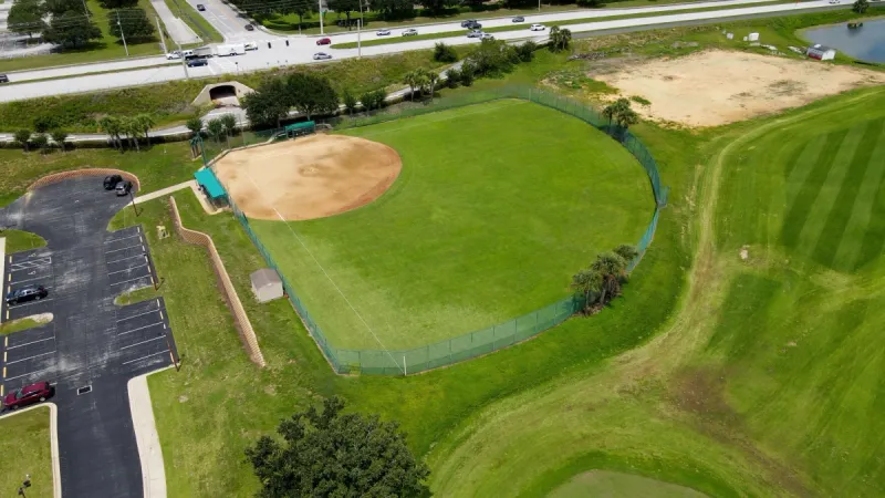 Softball court overlooking pond and golf greens.
