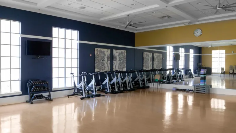 Aerobics room with weights and exercise bikes.