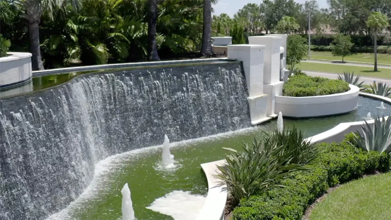 A stunning water fountain surrounded by lush tropical greenery.
