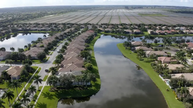 Aerial view of Valencia Cove community showing homes, water features, and surrounding land.