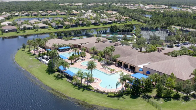 Aerial view of the Valencia Lakes clubhouse and pool overlooking the lake.