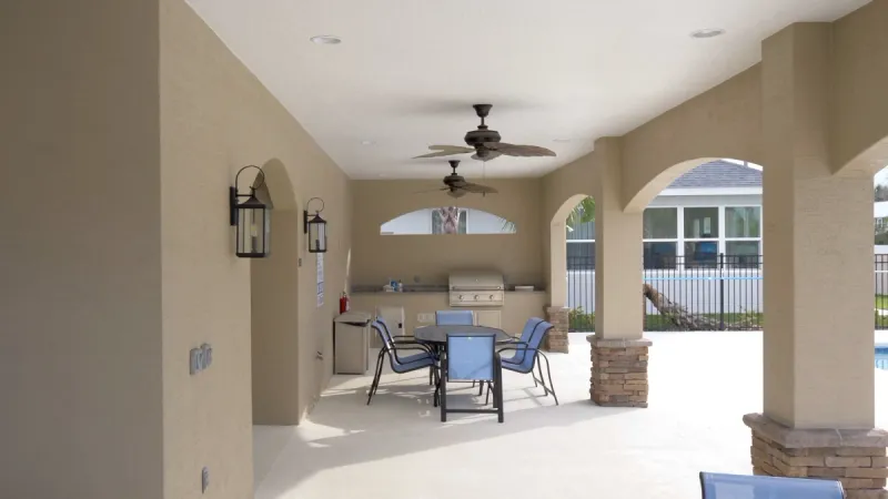 The Matanzas Lakes community grilling area with stainless steel grill and seating area.