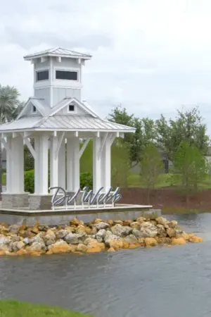 The Del Webb Bexley monument sign creates a captivating focal point in a lake.