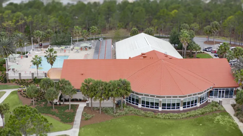 Large amenity center with an outdoor pool and lounge area.