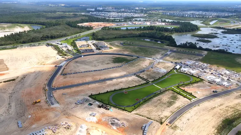 A aerial view of Del Webb Oasis construction with roads and buildings.