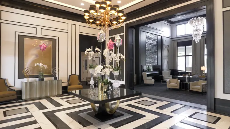 The elegant Valencia Bay lobby entrance with a floral display and grand chandelier.