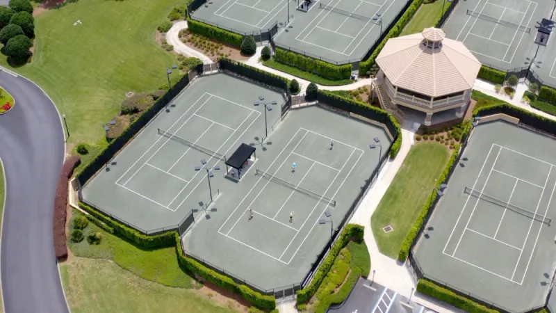 Multiple tennis courts surrounding gazebo area.