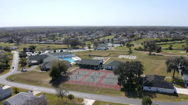 Ocala Palms clubhouse with tennis courts in the foreground.