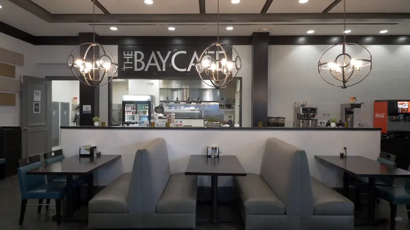 The cozy Bay Café with booth seating and modern chandeliers.