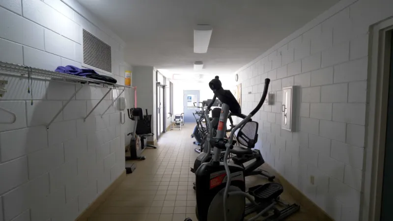 A fitness area with several types of exercise equipment neatly arranged along the wall.