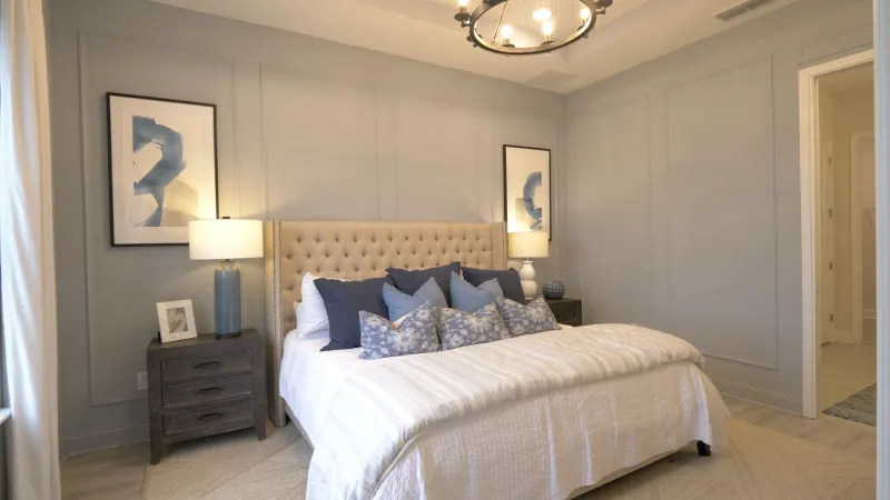 A well-appointed bedroom, featuring a comfortable king bed, artistic wall decor, and a chic light feature.