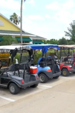 Multiple golf carts parked in front of the Pennbrooke Fairways golf club.