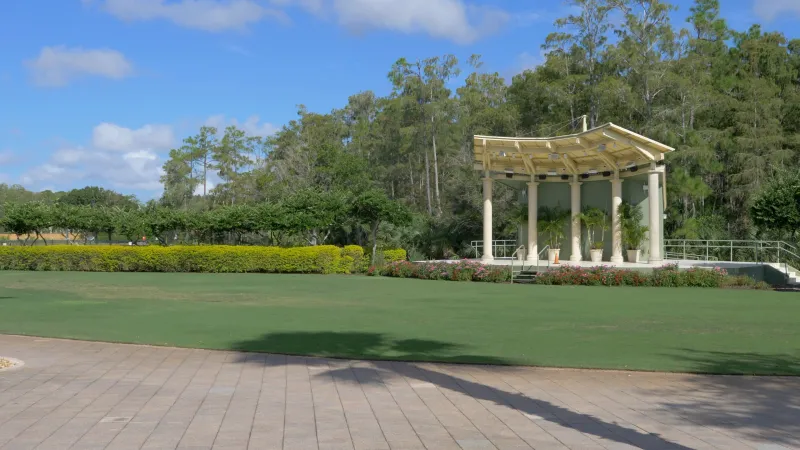 A gazebo stands amidst vibrant greenery at Pelican Preserve, offering a peaceful gathering spot.