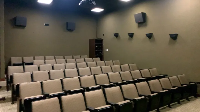 Movie theater with ample seating and premium sound system.