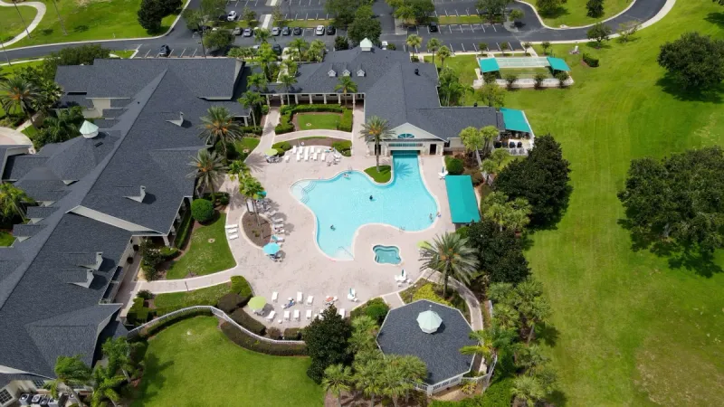 Aerial view of pool, gazebo, and small sports courts.