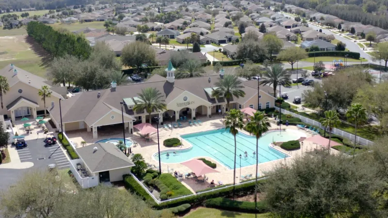 A clubhouse and amenity center with a large pool.