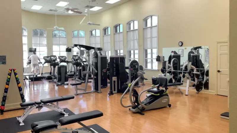 Fitness center with a variety of gym equipment for resident use.