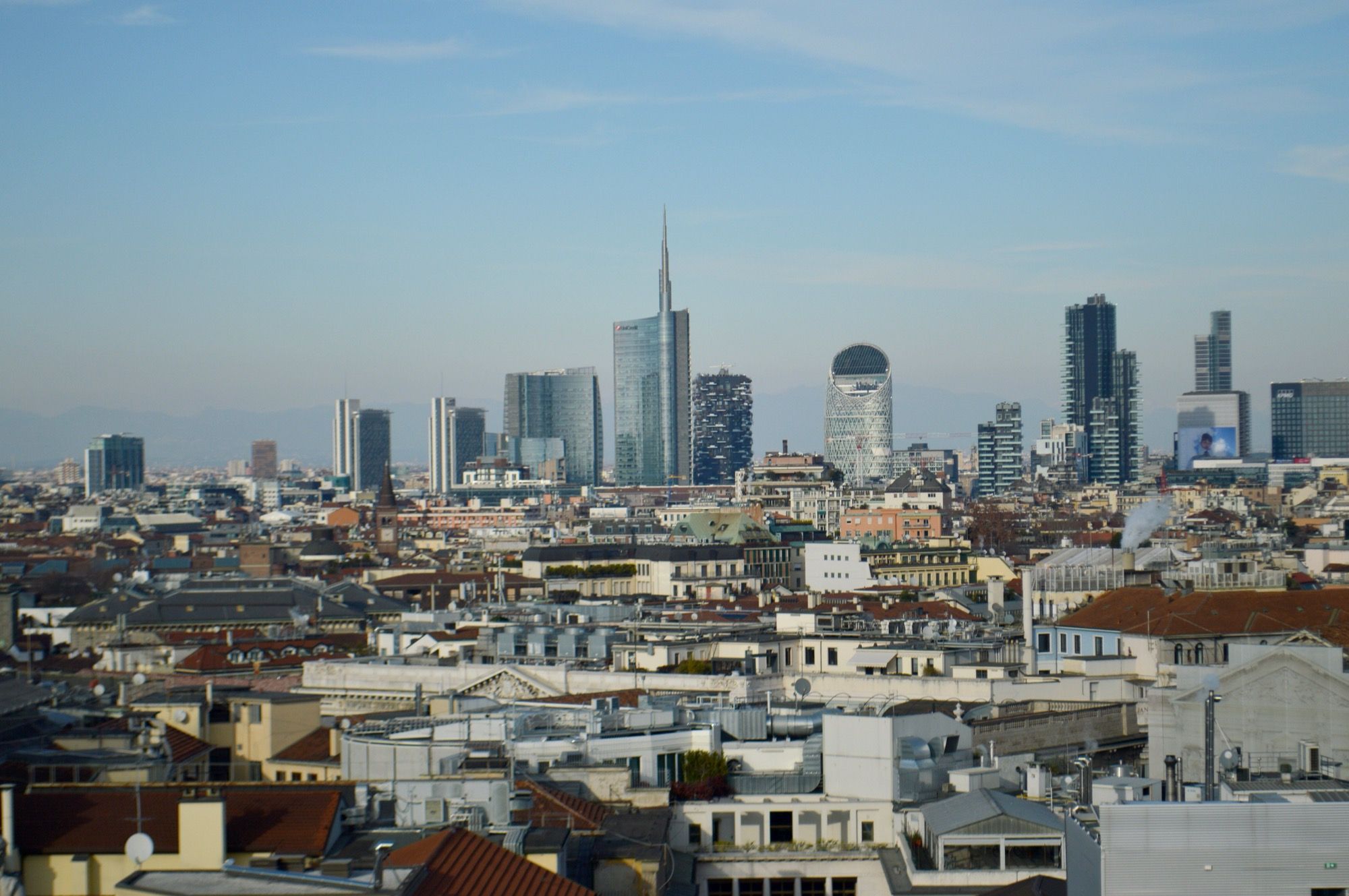 Modern towers and lower city buildings across Milan’s skyline.