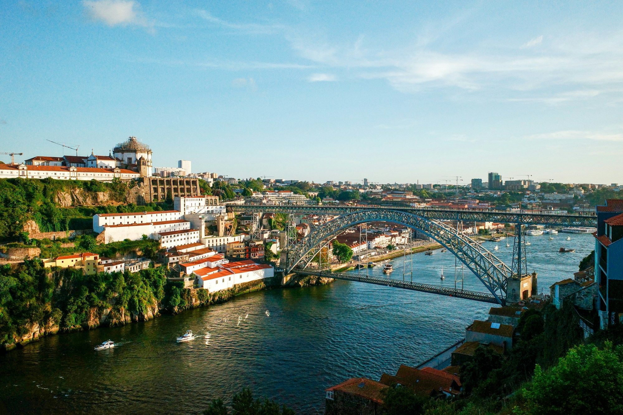 The Dom Luís I Bridge over the Douro in Porto, with the Serra do Pilar monastery on the hill across the river.